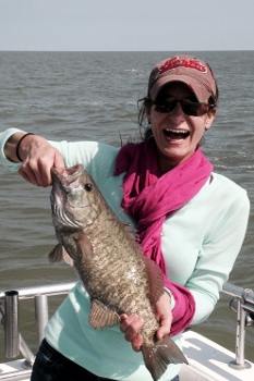 Young lady with a bass she just caught