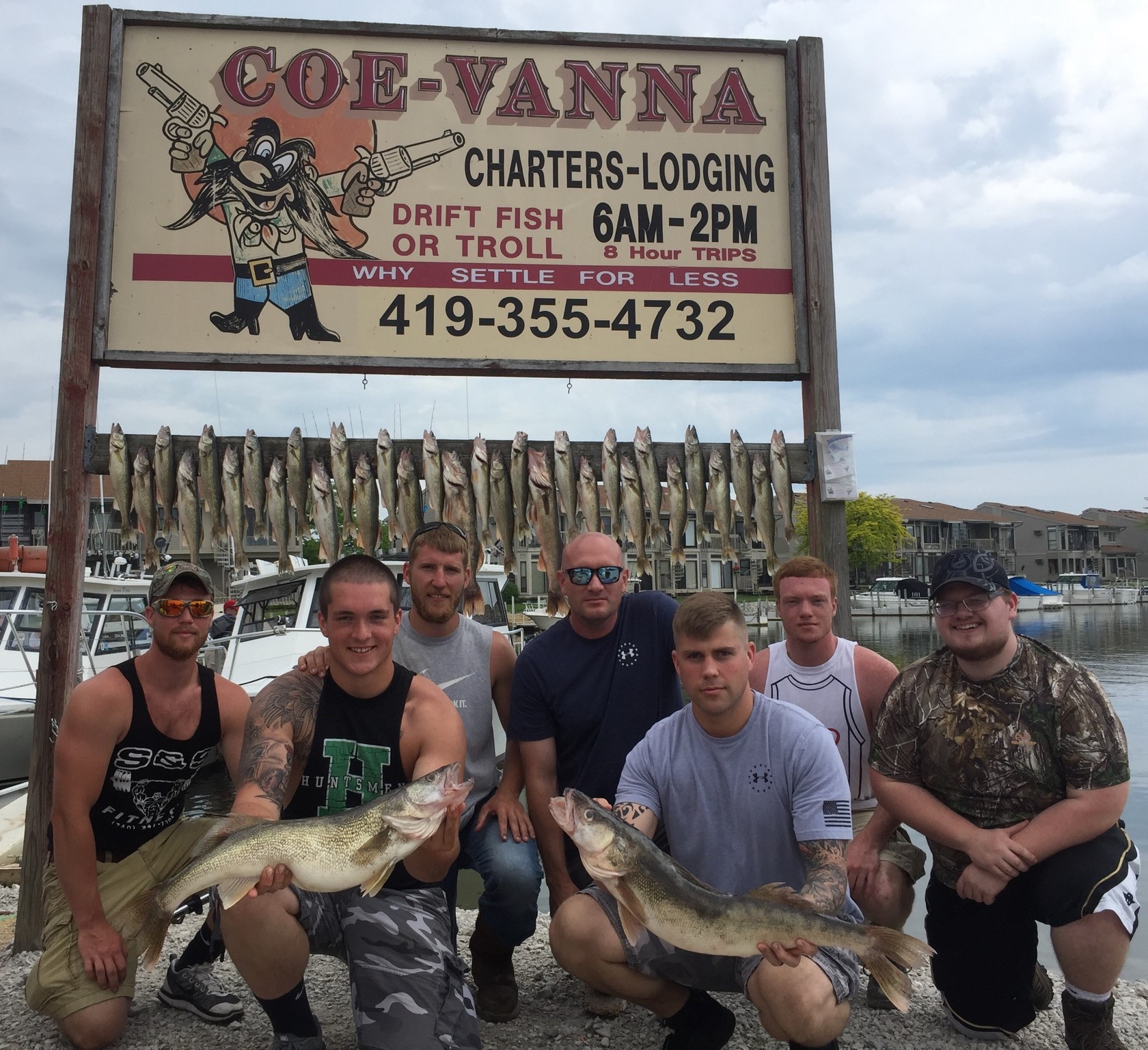 Group of anglers holding a limit of Lake Erie walleye on the dock